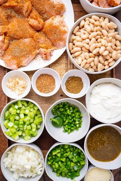 the ingredients are laid out on the table to make this chicken dish, including onions, celery, and beans