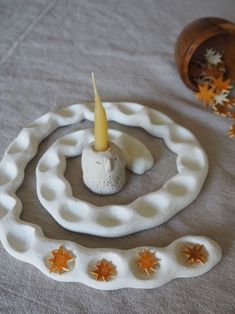 a white candle holder sitting on top of a table