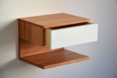 a wooden shelf with two drawers attached to it