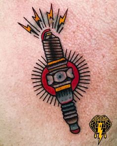 an image of a tattoo on the back of a man's chest with a screwdriver