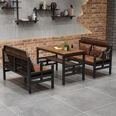 two chairs and a table in front of a brick wall with shelves on the side