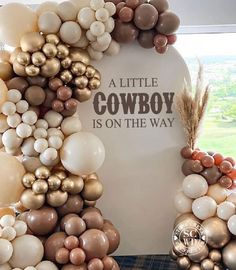 balloons are arranged in the shape of a cowboy's head and words on it