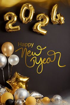 balloons and streamers with the words happy new year written in gold on a black background