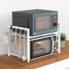 two microwaves are stacked on top of each other with food in the door and cooking utensils