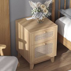 a wooden nightstand with two drawers next to a bed