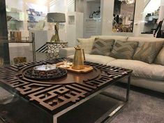 a living room filled with lots of furniture and decor on top of a coffee table