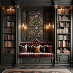 a room with bookshelves filled with lots of books and pillows on top of it