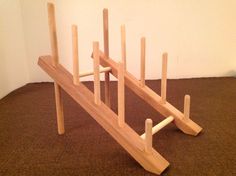 a wooden rack with several sticks sticking out of it's sides on the floor