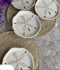 three white plates with dragonflies on them