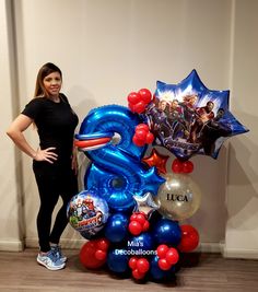 a woman standing next to a giant balloon shaped like an elephant with balloons on it