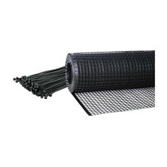 a roll of black wire mesh on top of a white surface with one end rolled up