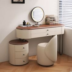 a dressing table with two stools and a round mirror on the wall above it