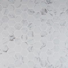 a white marble tiled wall with hexagonal tiles