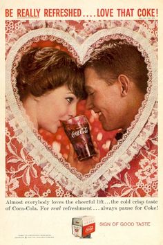 an advertisement for coca cola in the shape of a heart with a man and woman looking into each other's eyes