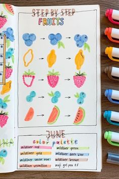 an open notebook with fruit and vegetables on it next to crayons, markers and pens