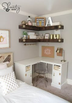 a white desk and shelves in a small room with a bed, chair and pictures on the wall