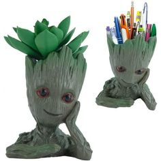 two planters with pens and markers in them, one has a face on it