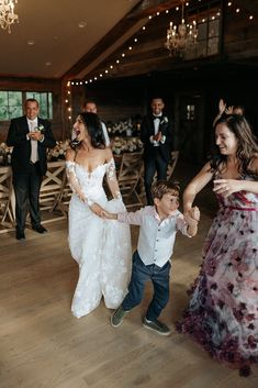 a group of people standing on top of a wooden floor