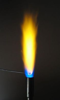 a blue and yellow flame is being lit on a black pole with a long wire