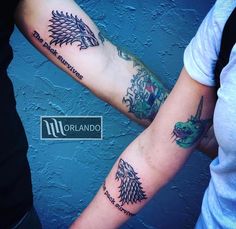 two people with matching tattoos on their arms