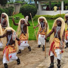 a group of people that are standing in the street with some sticks and poles on their heads