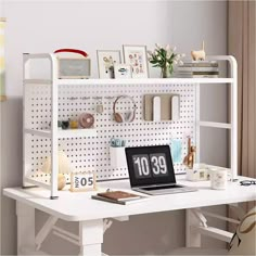 a laptop computer sitting on top of a white desk