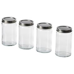 four glass jars with metal lids are lined up