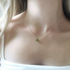 This genuine peridot gemstone sits on a dainty gold filled, sterling silver, rose gold filled or 14k gold chain. Subtle and simple, this beautiful semi-precious stone necklace is perfect by itself or for layering with other necklaces. Peridot is the birthstone for August. Jewelry is handmade by us in NYC focusing on quality using only the highest quality materials and handpicked genuine gemstones. The length on the model is 16 inches. ▹ PACKAGING All jewelry is beautifully wrapped in tissue and Dainty 14k Gold Charm Necklace For May Birthstone, Dainty 14k Gold May Birthstone Charm Necklace, Yellow Gold Dainty Necklace For May Birthstone, Delicate May Birthstone Round Pendant, Round Peridot Birthstone Necklace, Delicate May Birthstone Necklaces For Her, Gold Peridot Jewelry With Gemstone, Delicate Necklace With May Birthstone, Gold Peridot Gemstone Jewelry