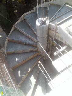 a spiral staircase made out of concrete and wood