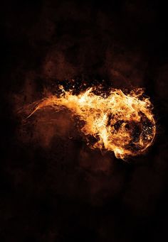 a dark background with yellow and orange fire