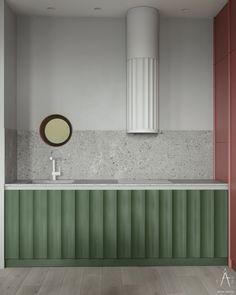 a bathroom with a sink, mirror and green cabinetry on the wall next to it