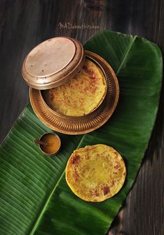 some food is sitting on top of a banana leaf