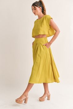 The Savannah Skirt Set is your perfect go-to for the summer. Crafted from a lightweight linen-like fabric, the midi-flare skirt comes with a side pocket for convenience, while the crop top offers an effortless fit. Keep cool and stylish in this comfortable and timeless set. This item runs true to size. Skirt has elastic in the waist. The top is a wide cut with no stretch. Lining. Self: 95% Rayon 5% Spandex Linning: 100% Cotton Skirt And Top Coord Set, Summer Coord Set, Wrap Skirt Outfit, Pink And Red Dress, Short Sleeve Floral Dress, Mustard Yellow Color, Black And Blue Dress, Crop Top Skirt Set, Coord Set