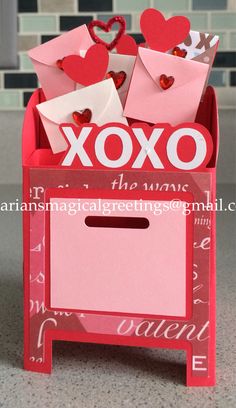 a valentine's day card box with hearts and envelopes