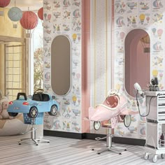 a child's room with toys and decorations on the walls, including a pink car