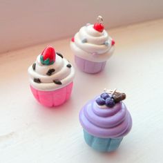 three miniature cupcakes with frosting and sprinkles