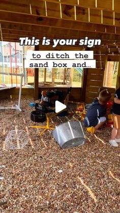 two children are playing in the sand box