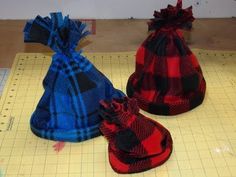 three bags sitting on top of a table next to a ruler and paper cutting board