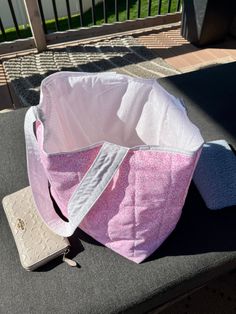 a pink and white bag sitting on top of a table