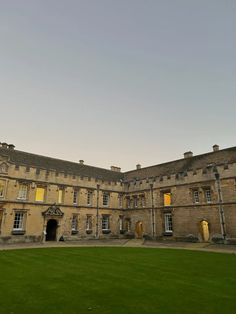 an old building with grass in front of it