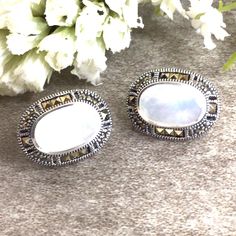 ✦Gemstone: Mother of Pearl/Marcasite ✦Material: Sterling Silver ✦Color: white ✦Shape: oval ✦Size: 23x14mm ✦Weight: 6.2g ✦QTY: 1 pair earrings / package ♕Beautiful & High Quality Findings♕ Mother Of Pearl is considered an auspicious stone for women. The luster and shine of the pearl resemble the beauty, grace, and elegance of a woman. Pearls signify wisdom, learning, creativity, perseverance, and purity to name a few. The color white symbolizes purity in many cultures and so too does Mother Of Pearl signify purity with its shiny lustrous white appearance. You will receive the same quality has you see in picture. CLICK BELOW TO CHECK ALL OUR BEAUTIFUL GEMSTONE BRIOLETTES. https://www.etsy.com/shop/TurquoiseFactory?ref=seller-platform-mcnav Color may vary slightly due to your monitors' color White Clip-on Jewelry As Gift, Classic White Oval Earrings, White Oval Earrings For Wedding, White Oval Earrings As Gift, White Oval Earrings For Anniversary, White Clip-on Jewelry For Gift, Classic White Gemstone Earrings, Oval Clip-on Earrings For Anniversary, White Clip-on Jewelry For Anniversary