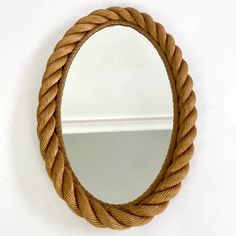 a round rope mirror hanging on the wall