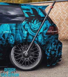 a blue dragon painted on the side of a car with a broom sticking out of it