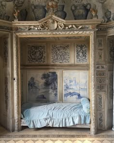 a bed in a room with paintings on the walls