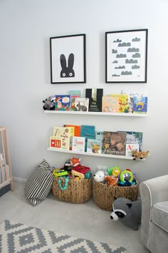 a baby's room with two bookshelves and toys in baskets on the floor