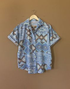 "Authentic vintage short sleeve button down shirt with 90's abstract design and oversized fit. Dates from early to late 90's. This shirt is in great clean condition with little signs of previous wear. Full button down front. Soft 100% cotton. Still has many years of wear left. Measurements (taken zipped/buttoned up and laid comfortably flat) x2 for circumference No Tag Size (Fits like Oversized Large) Shoulders 46\"/48\" Chest 44\" Bottom hem circumference 44\" Sleeve 6\" Top arm circumference 1 Casual Patterned Blouse With Vintage Print, Patterned Short Sleeve Shirt With Buttons, Trendy Patterned Button-up Shirt, Casual Patterned Blouse With Retro Print, Casual Collared Blouse With Vintage Print, Bohemian Short Sleeve Shirt, 90s Graphic Print Camp Shirt With Short Sleeves, 90s Style Camp Shirt With Graphic Print, 90s Style Short Sleeve Camp Shirt With Graphic Print