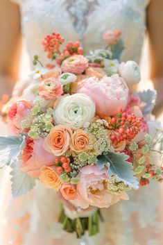 a bride holding a bouquet of flowers in her hands