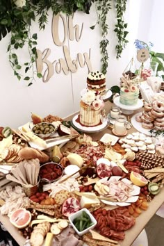 a table filled with lots of different types of food and desserts on top of it