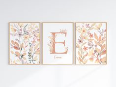 three floral wall art prints with the letter e in gold, orange and pink colors