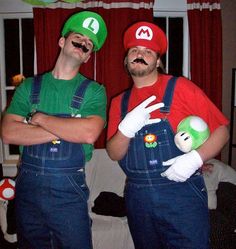 two men in mario bros costumes standing next to each other